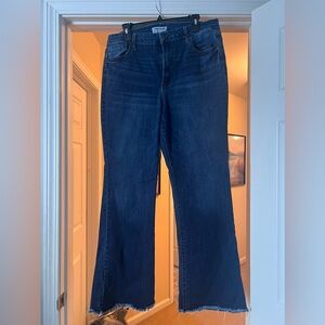 Dark wash flare jeans with raw/frayed hem